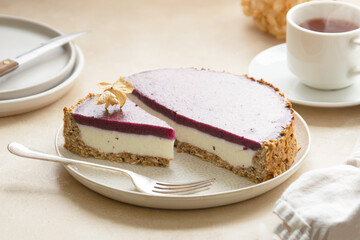 Whole cheesecake with berries and green mint. Gluten and sugar free vegan, healthy cake.