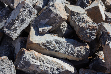 Broken concrete pillars. Fragments of used broken concrete. Construction material