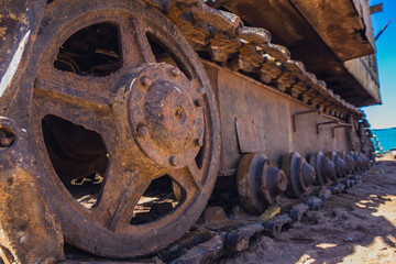Old crawler crane at a construction site. Excavator tracks covered in dirt on the construction site