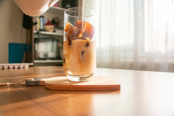 Making a refreshing drink by making ice cubes from coffee and pouring milk into a glass. A refreshing drink cold coffee on a summer morning.