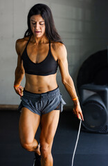 Fototapeta na wymiar Athletic woman with a jump rope