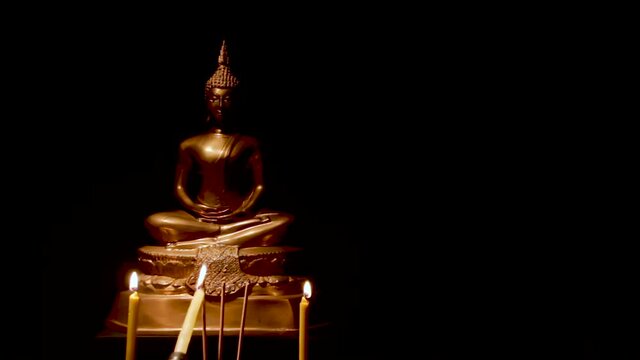 Burning incense and candles to pay homage to the Buddha images, , on black background,in Thai tradition