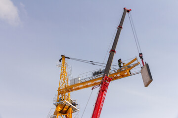 Construction crane assembly stage. Tower crane assembly. Installation of a construction crane before starting construction.