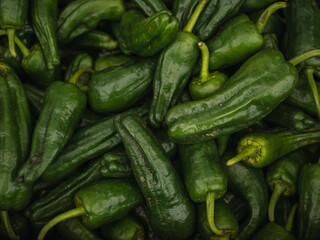 Background of natural green peppers from a local market, filling the entire frame. fresh and healthy food concept