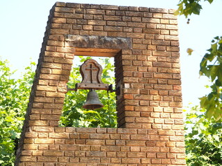 campanario con campana de la hermita de san Cristóbal de borges blanques, construido en piedra color marron, lerida, españa, europa