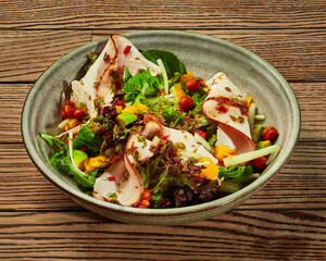 Salad of greens with avocado, mango, baked ham and fried chickpeas