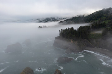 Fog drifts across the scenic coast of southern Oregon. This rugged and rocky part of the Pacific Northwest is found along the Samuel H. Boardman State Scenic Corridor.