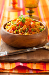 Bulgur  with vegetables in wooden bowl