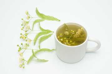 Linden flowers in a cup isolated on white background, linden tea