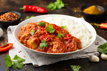 Spicy Chicken Pathia curry with basmati rice in a white plate. healthy food.