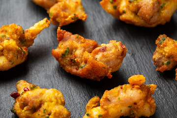 Chicken Pakora dish with sweet chilli sauce on rustic stone board
