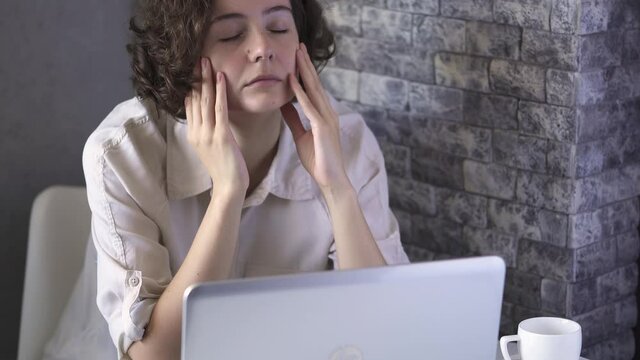 Tired girl suffering from pain, massage whiskey, work fatigue, stressful woman suffering, despair, anxiety, insomnia Headache, migraine, nervous overexertion, depression concept. Work in spite of pain