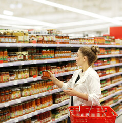 Woman choosing a dairy products at supermarket