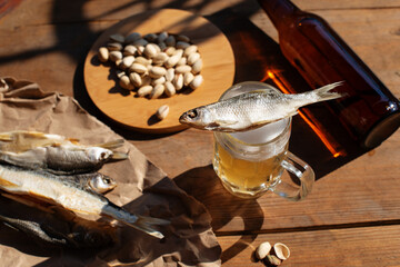 Cold beer and dried salted fish. Top view. Summer, hard shadows, relax, holyday