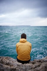 Man in yellow jacket waiting for the storm