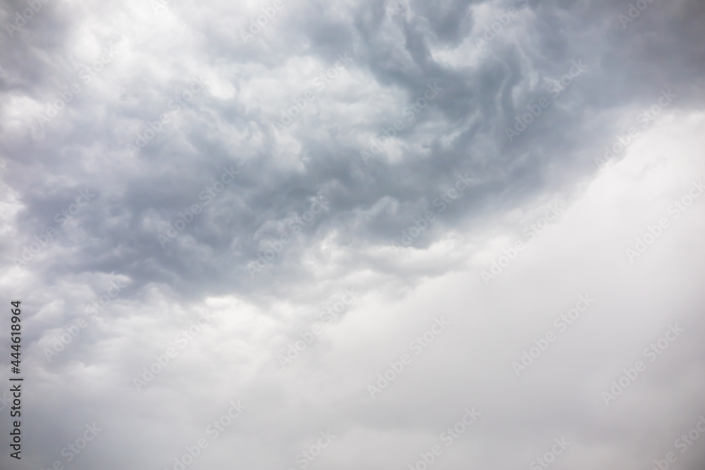 Wall mural overcast weather above dark grey sky. aggressive rain clouds floating before thunder storm, abstract