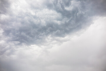 Fototapeta premium Overcast weather above dark grey sky. Aggressive rain clouds floating before thunder storm, abstract of nature. Dramatic mood scene environment background. Natural cloudscape in dull and moody weather