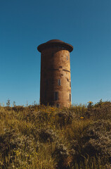 Ancient tower on a beautiful summer day with blue sky. This iconic landmark is the main tourist attraction of Domburg, a picturesque town in zeeland close to the northsea.
