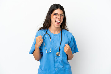 Young surgeon doctor caucasian woman isolated on white background celebrating a victory in winner position