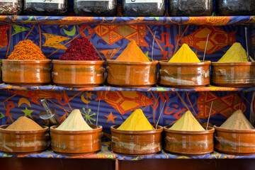 Various spices and herbs in clay pots. Asian spice market