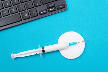 Vaccination, Immunology or Revaccination Concept - A Medical Syringe Lying on Blue Table in...