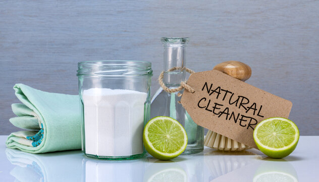 homemade natural eco cleaner with soda, vinegar and lime in recycled jars and bamboo made scrubbing brush, sustainable living
