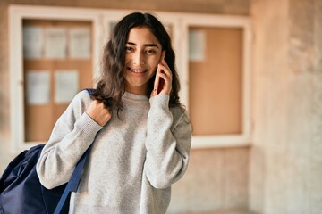 Young middle east student girl smiling happy talking on the smartphone at the city.