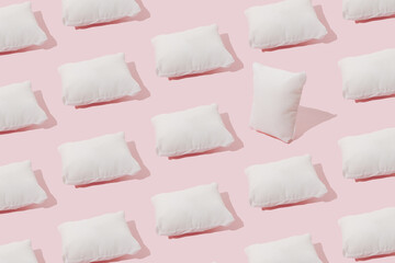 White pillow on a pink background. Minimal pattern.