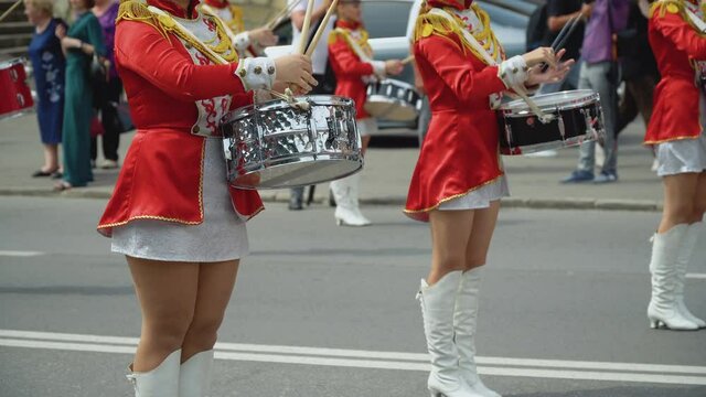 Young girls drummer in red vintage uniform at the parade. Street performance. Parade of majorettes