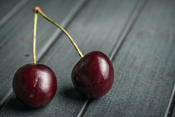 Fresh juicy cherries. Red cherry on a dark background. Macro photo.