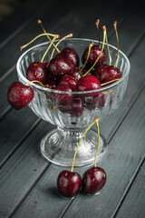 Fresh juicy cherries. Red cherry on a dark background. Macro photo.