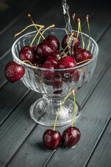 Fresh juicy cherries. Red cherry on a dark background. Macro photo.