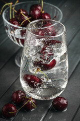 Fresh juicy cherries. Red cherry on a dark background. Macro photo.