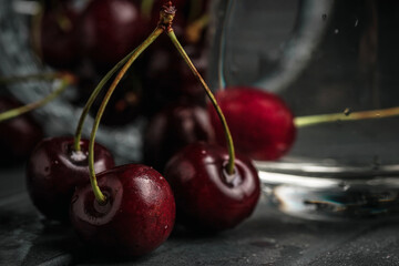 Fresh juicy cherries. Red cherry on a dark background. Macro photo.
