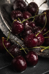 Fresh juicy cherries. Red cherry on a dark background. Macro photo.