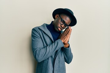 Young african american man wearing elegant style sleeping tired dreaming and posing with hands together while smiling with closed eyes.