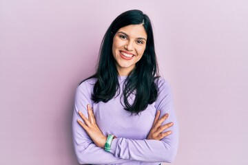 Fototapeta premium Young hispanic woman wearing casual clothes happy face smiling with crossed arms looking at the camera. positive person.