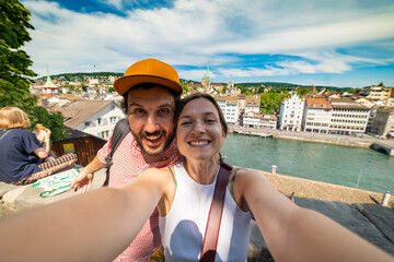 happy tourist couple friends taking a selfie photo in Zurich, Switzerland - obrazy, fototapety, plakaty
