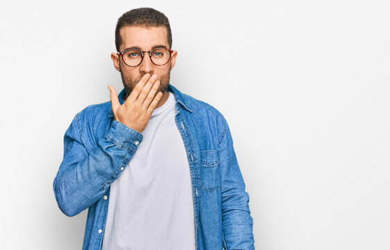 Young caucasian man wearing casual clothes bored yawning tired covering mouth with hand. restless and sleepiness.