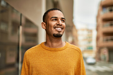 Fototapeta premium Young african american man smiling happy standing at the city.