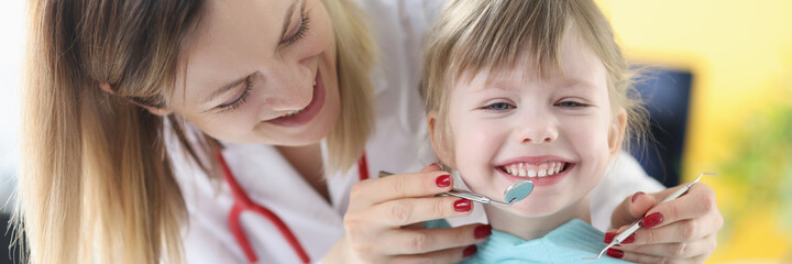 Dentist doctor examine teeth of little girl