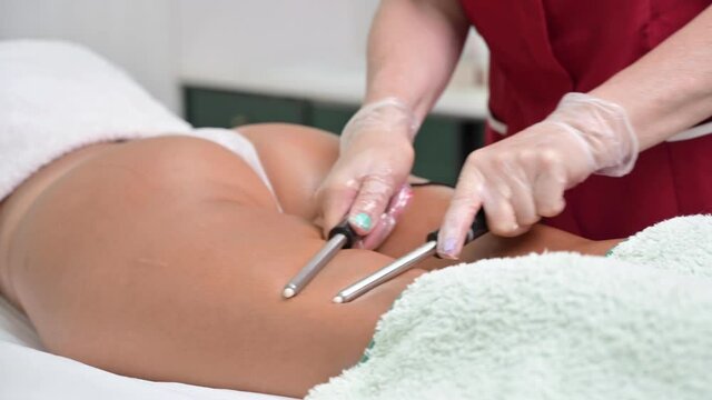 Woman having cosmetic galvanic beauty treatment in spa. Therapist applying low frequency current. High quality 4k footage