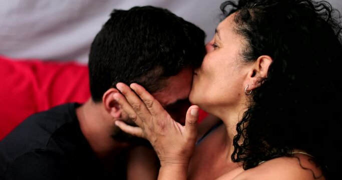 Latin mature mother kissing son. South American hispanic people love and affection togetherness