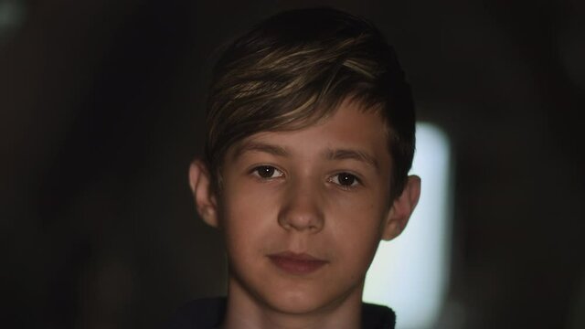 portrait of a boy looking at the camera, gullible boy with wide eyes, moving camera, cinematic shot