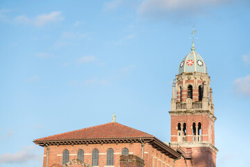 Exterior of a tower on top of an old building with bricks