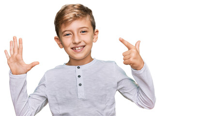 Little caucasian boy kid wearing casual clothes showing and pointing up with fingers number seven while smiling confident and happy.