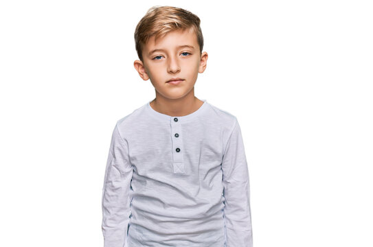 Little caucasian boy kid wearing casual clothes relaxed with serious expression on face. simple and natural looking at the camera.