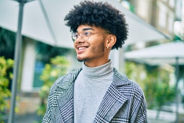 Young african american businessman smiling happy standing at the city.