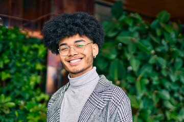 Young african american businessman smiling happy standing at the city.