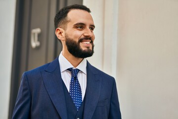 Young businessman smiling happy standing at the city.